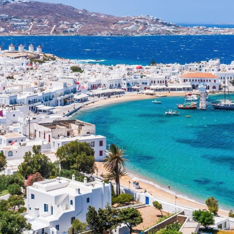 Participants at Breathe the Blue Money Retreat in Mykonos, July 11-17, practicing energy alignment with breathtaking sea views